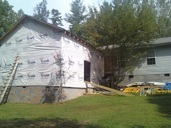Tyvek wrapped gable on a new room addition beside an existing home in Bowling Green